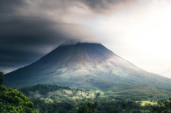 Costa Rican volcano under shifting clouds during the green season